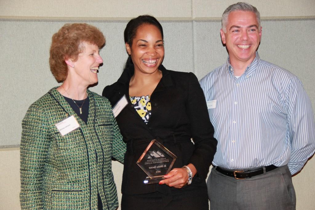 Chancellor of Pierce College Michelle Johnson and Board President Pat Lewis stand with Alumni Sheley Secrest