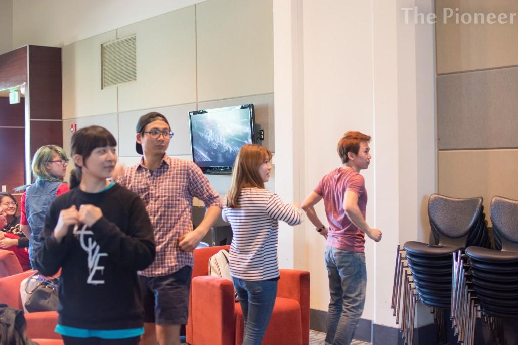 You Suha, Violet Kim, James Jung, and Micheal Hwang playing a dancing game at the game day.