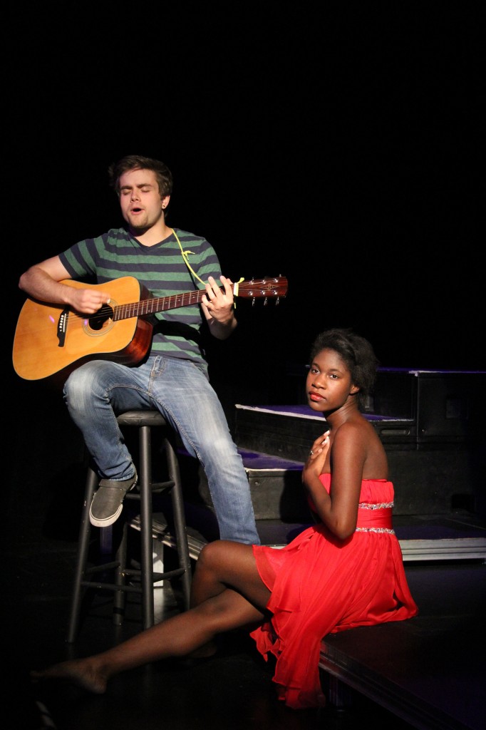 Jonny Barret performs an original song titled: Travelers Journey, while Kache Waters sat by his side.
